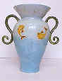 I find ceramics fascinating. I'm technically minded so ceramics suit me. This vase is a smaller version of a piece I made to commission for a hospital corridor window. It's decorated using coloured slips and a transparent glossy glaze.